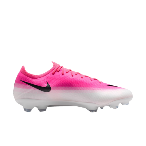 Profile view of a pink and white gradient Nike soccer cleat with a black swoosh and white studded soleplate.