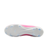 The white soleplate of a pink soccer cleat with translucent blue chevron and conical studs on a white background.