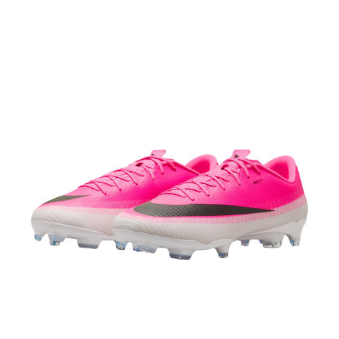 A pair of bright pink and white Nike soccer cleats with a black swoosh, positioned against a plain white background.