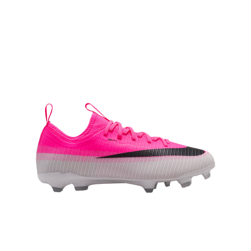 A bright pink and white Nike soccer cleat with a large black swoosh, pink laces, and a studded white sole.