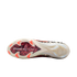 A close-up, bottom view of a soccer cleat's outsole against a solid black background. The cream-colored sole features six bright red-orange studs in the forefoot and a central red and black leopard-print pattern with white "AIR ZOOM" text. The heel sectio
