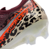 A close-up view of the heel of a Nike soccer cleat featuring a vibrant leopard print in black, orange, and beige. The text "NIKE UNITED 003" is visible along a silver stripe, and the shoe has a translucent white soleplate with clear studs.
