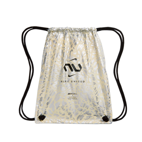A cream-colored drawstring bag featuring a metallic silver animal print pattern. A black Nike United "NU" logo and two small Nike swooshes are printed in the center. Small text at the bottom reads "MERCURIAL x Lauren James Salma Paralluelo." The bag has b