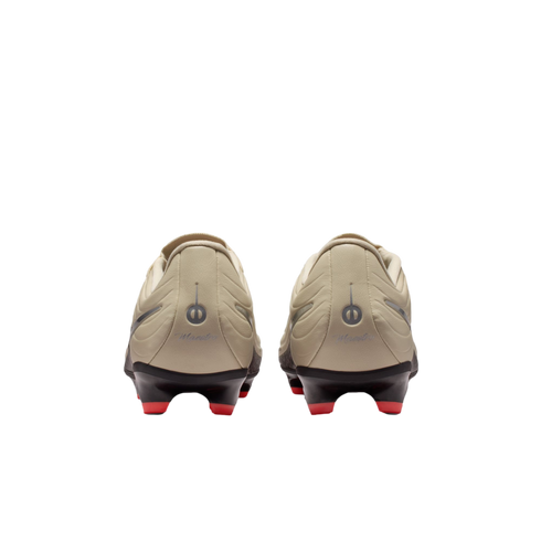 Back view of beige soccer cleats with red studs on a black background. The heels feature a circular logo and "Maestro" script.