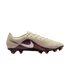 Side view of a beige Nike soccer cleat with a maroon leopard-print panel, a silver swoosh, and a black soleplate with red studs.