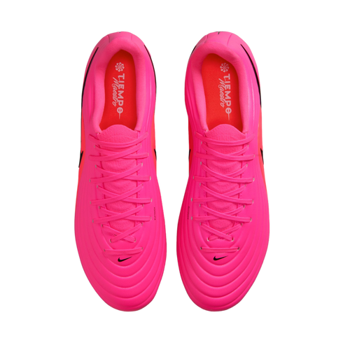 Top-down view of a pair of bright pink Nike soccer cleats with matching laces and red insoles on a white background.