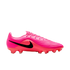 A profile view of a bright pink Nike soccer cleat with a large black swoosh, pink laces, and red-toned studs, set against a plain white background.