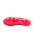 Underside view of a pink Nike Tiempo soccer cleat, featuring a translucent pink soleplate with traction studs and a small black swoosh logo.