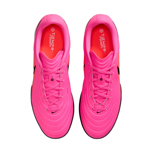 Top-down view of bright pink Nike Tiempo Maestro soccer cleats with orange insoles and black details on a white background.