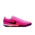 A bright pink Nike turf soccer shoe featuring a black swoosh, orange detailing, and a black studded outsole on a plain white background.