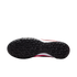 Bottom view of a Nike athletic shoe featuring a black textured rubber outsole with a geometric pattern, with pink and white accents on the midsole, against a white background.