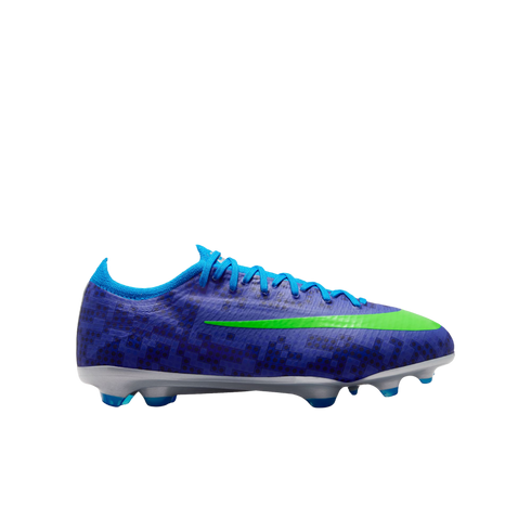Side view of a blue soccer cleat with a dark blue grid pattern, featuring a lime green swoosh and a silver soleplate with blue studs.