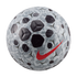 A light gray Nike soccer ball featuring a dark gray camouflage pattern, textured black pentagonal shapes, and a bright red swoosh logo, set against a solid black background.