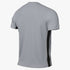 Rear view of a light gray, textured short-sleeved athletic t-shirt with a vertical black stripe on the side.