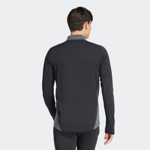 Back view of a man wearing a black long-sleeved athletic top with grey side panels and collar, paired with black pants.