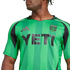 A person wearing a green and black striped Austin FC soccer jersey with the "YETI" logo on the front.
