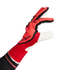 Red and black Adidas Predator goalkeeper glove shown from a side profile against a solid green background.