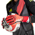 Goalkeeper in a patterned jersey and red Adidas gloves holding a soccer ball.