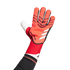 An Adidas Predator goalkeeper glove in red and white, worn on a hand against a solid green background.