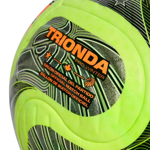 Close-up of a neon yellow and grey soccer ball branded "TRIONDA PRO WINTER" and labeled as an "OFFICIAL MATCH BALL" with orange graphic details.