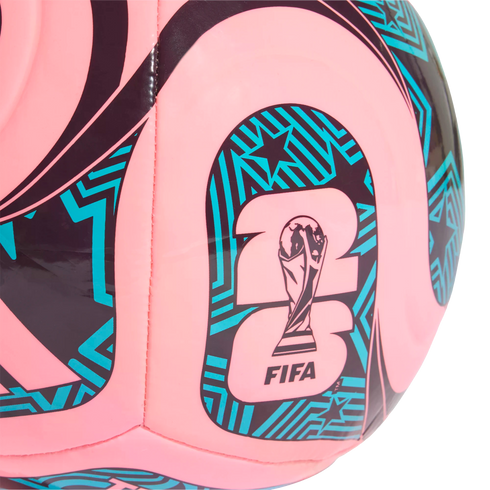 Close-up of a pink soccer ball with teal and black patterns. The center shows the official 2026 FIFA World Cup trophy logo.