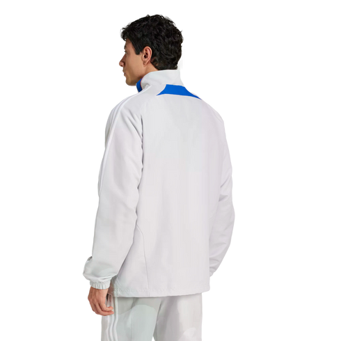 Rear view of a man wearing a light grey Adidas track jacket with blue accents and matching track pants against a plain white background.