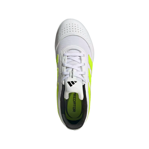Top-down view of a white Adidas Predator soccer shoe with lime green accents and a black interior, set against a black background.