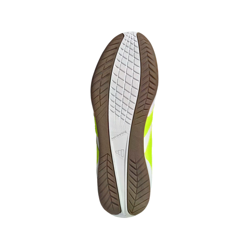 View of an Adidas sneaker's non-marking sole with white and brown gum rubber tread patterns and bright lime yellow side panels against a black background.