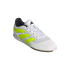 A white Adidas Predator indoor soccer shoe with neon yellow stripes and a gum sole, shown from a three-quarter angle against a black background.