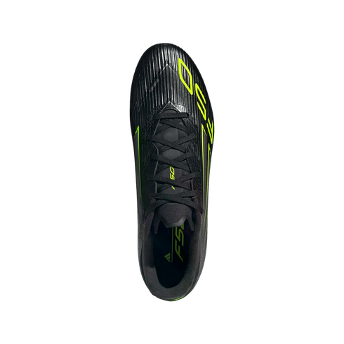 Top-down view of a black Adidas soccer cleat with neon yellow accents and "F50" branding against a solid black background.