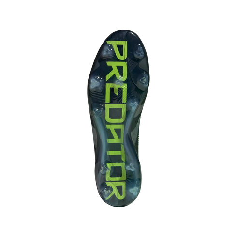 Bottom view of a dark Adidas Predator soccer cleat outsole featuring large, lime green "PREDATOR" branding and clear studs against a black background.