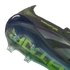 Close-up of a black Predator soccer cleat's heel and soleplate, featuring lime green accents and a translucent control frame with studs against a black background.