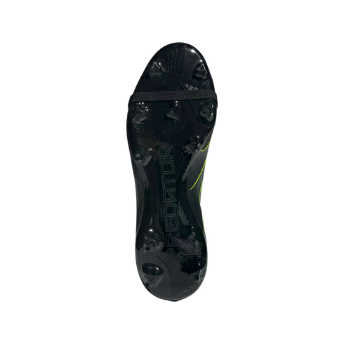 The soleplate of a black Predator soccer boot, featuring molded studs, an embossed logo, and a black elastic forefoot strap.