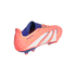 Side view of an orange Adidas Predator soccer cleat with three white stripes and blue trim, showing firm ground studs.