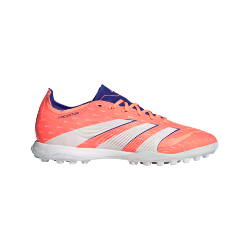 Profile view of a bright coral Adidas Predator soccer shoe with white stripes and purple details, featuring a turf-cleat sole, set against a black background.