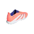 A bright coral Adidas Predator soccer shoe featuring white stripes and a blue interior, designed for turf play with a white studded sole.