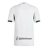 Back view of a white short-sleeved sports jersey with black and gold sleeve trim and a large "Guidehouse" logo printed near the bottom hem.