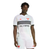 A man wearing a white D.C. United soccer jersey with three black chest stripes, red bird crests, and matching white shorts against a solid black background.