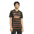A man wears a black Dallas Burn soccer jersey with red and gold stripes and logos, set against a solid black background.