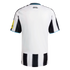 Rear view of a white short-sleeved sports jersey with black stripes on the sleeves and lower back, featuring "HOWAY THE LADS" text below the blue-trimmed collar.