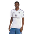 A man modeling a white Manchester United soccer jersey with a Snapdragon logo, posed against a black background.