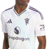 A person wearing a white Manchester United football jersey with purple accents, featuring the club crest, Adidas logo, and Snapdragon sponsor.