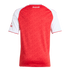 Rear of a red and white Arsenal jersey with a tonal monogram pattern and the word "Arsenal" in white script on the upper back.
