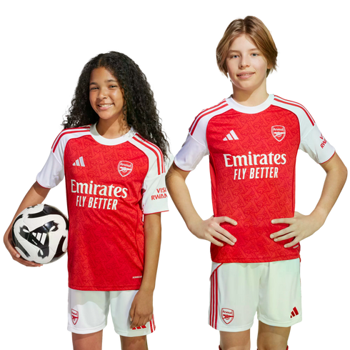 Two children in Arsenal FC home kits; a girl holds a football, and a boy stands with hands on hips. Both smile against a plain white background.