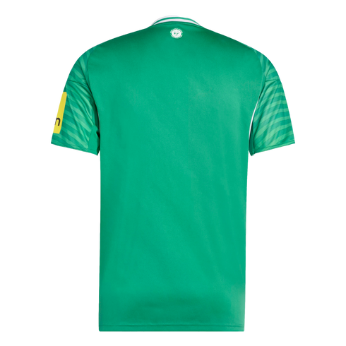 The back of a green Newcastle United football jersey featuring patterned sleeves, white collar trim, and a small club crest positioned just below the neckline.