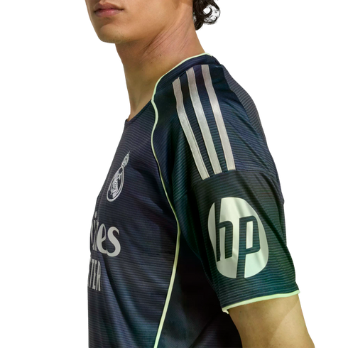 Side profile of a person wearing a dark navy Real Madrid soccer jersey with neon yellow accents and a prominent white HP logo on the sleeve.