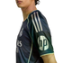 Side profile of a person wearing a dark navy Real Madrid soccer jersey with neon yellow accents and a prominent white HP logo on the sleeve.