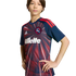 A young person wearing a New England Revolution soccer jersey with a red sunburst pattern and Gillette sponsor logo, posing against a solid black background.