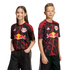 A young girl and boy pose in black New York Red Bulls soccer jerseys with red lightning patterns against a solid black background.