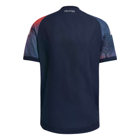 Back view of a navy blue soccer jersey with red and teal patterned sleeves and the word "HOUSTON" printed on the back neck.